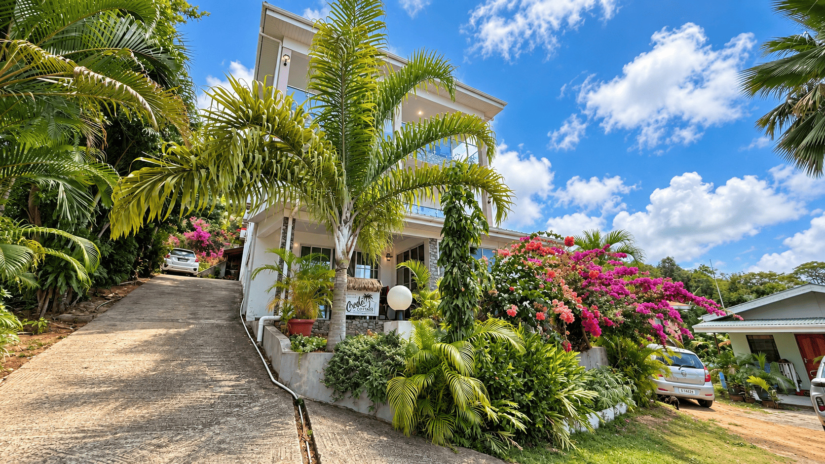 Path lined with bougainvillea at Creole Cottage Apartment looking towards the hills