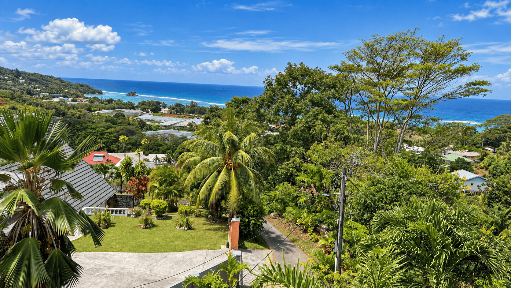 View from Creole Cottage Apartment over the green Anse Royale valley and the ocean